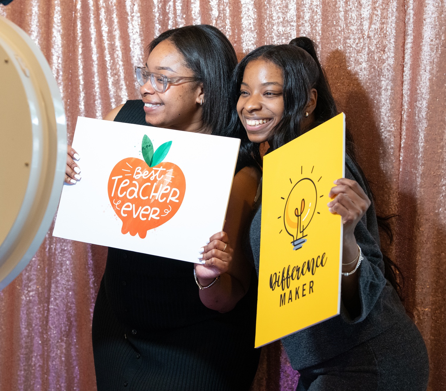 Rhapsidy Holt, an educator at C.T. Walker Traditional Magnet School, and Olivia Holt pose for a photo in the event’s photobooth.
